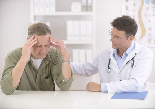 Neurology doctor comforts a patient suffering with migraines