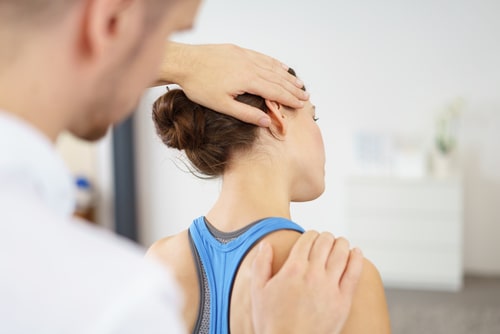 Chiropractor treats a woman's neck injury