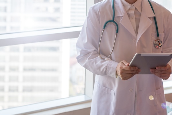 A doctor reviews patient notes