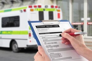 Hand With Accident Report Form by Ambulance, Car Accident Medical Records