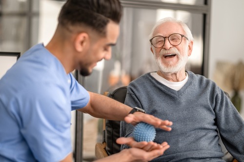 Physical Therapist With Patient Administering Hand Therapy