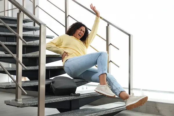 A woman recoils in pain after a slip-and-fall accident hurt her back.